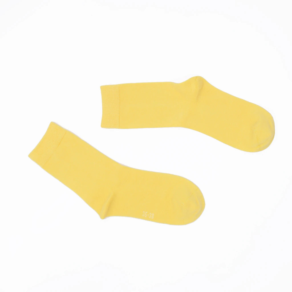 Pair of yellow socks on a white background