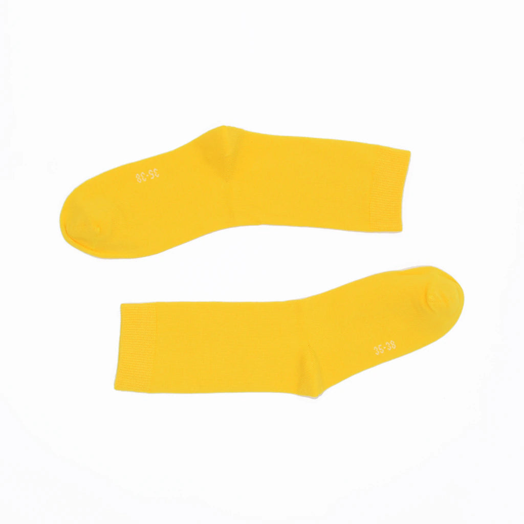 Two yellow socks on a white background