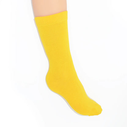 Leg modelling yellow socks on a white background