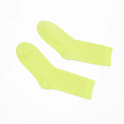 Pair of chartreuse socks on a white background