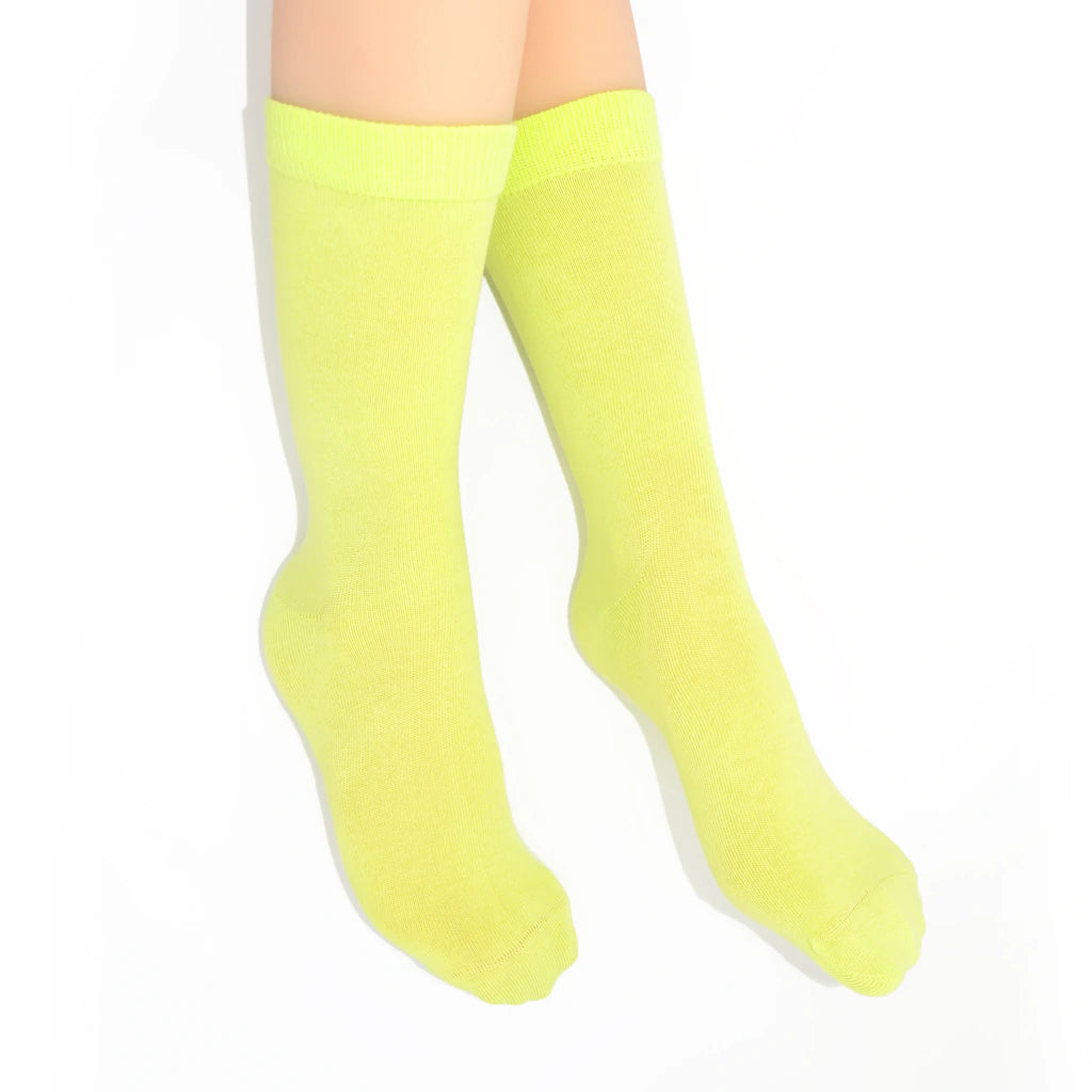 Legs modelling chartreuse socks on a white background