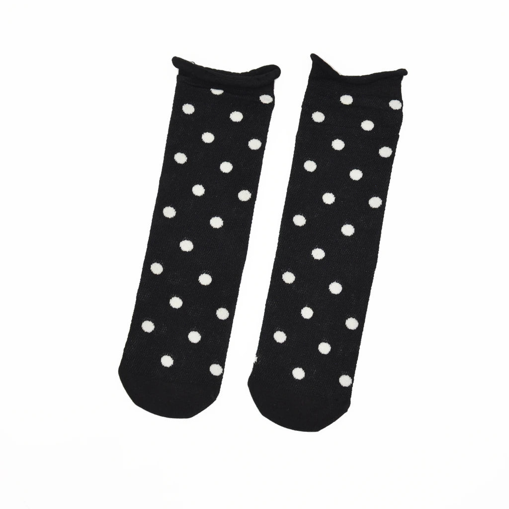 A pair of black ankle socks with a white polka dot pattern, displayed flat against a plain white background.