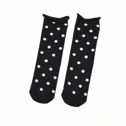 A pair of black ankle socks with a white polka dot pattern, displayed flat against a plain white background.