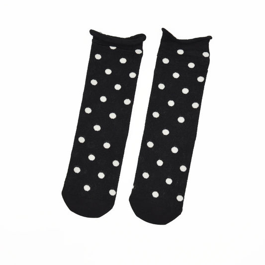 A pair of black ankle socks with a white polka dot pattern, displayed flat against a plain white background.