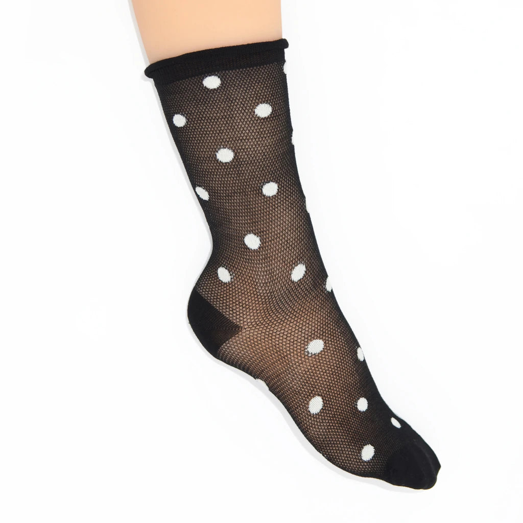 A single black fishnet toe sock with white polka dots, shown on a  foot against a plain white background.