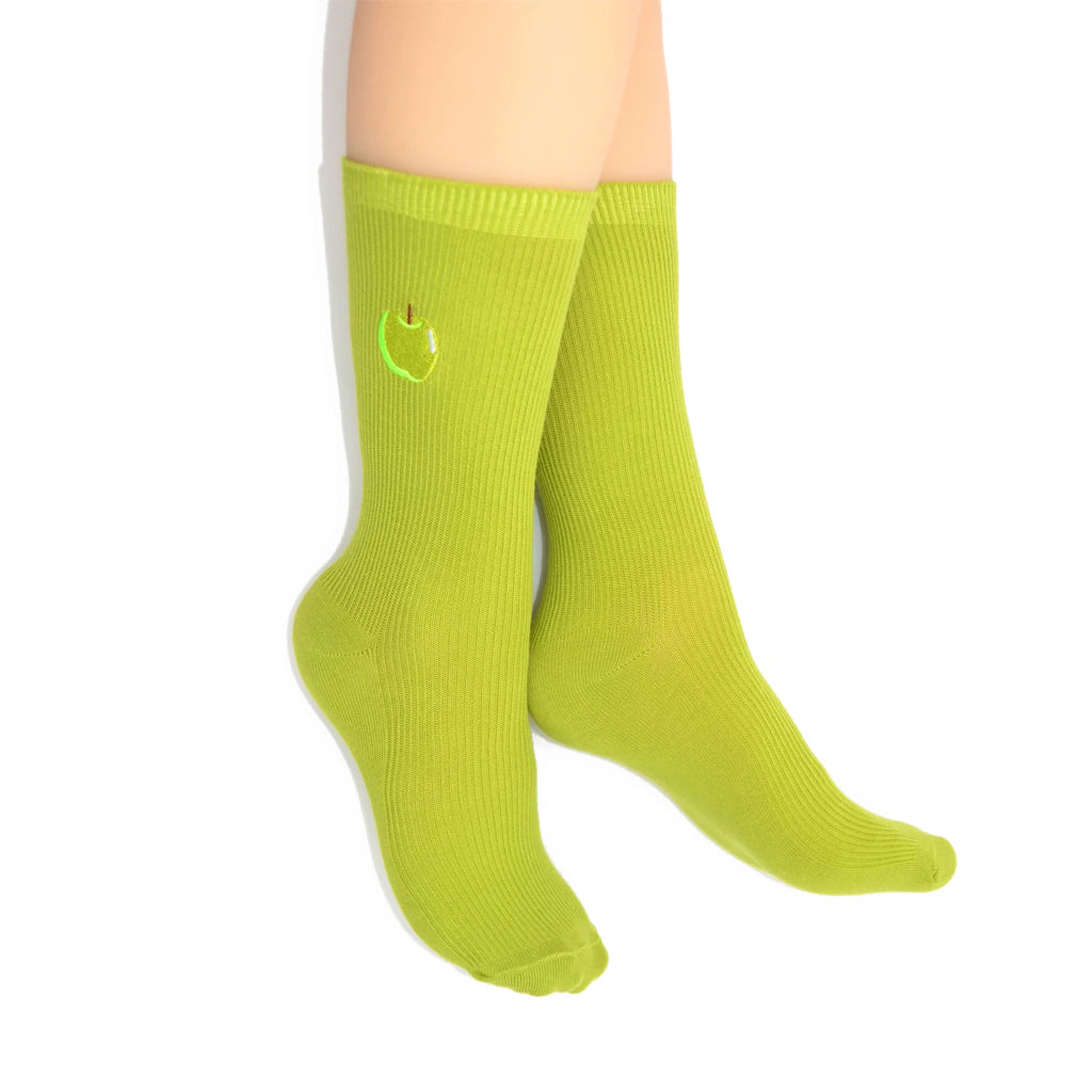 Green crew socks with an apple design on a white background