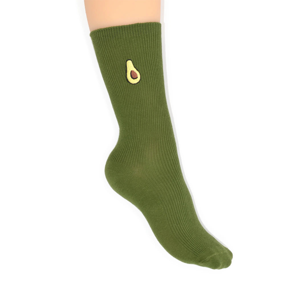 Green sock with avocado design worn by a person on a white background