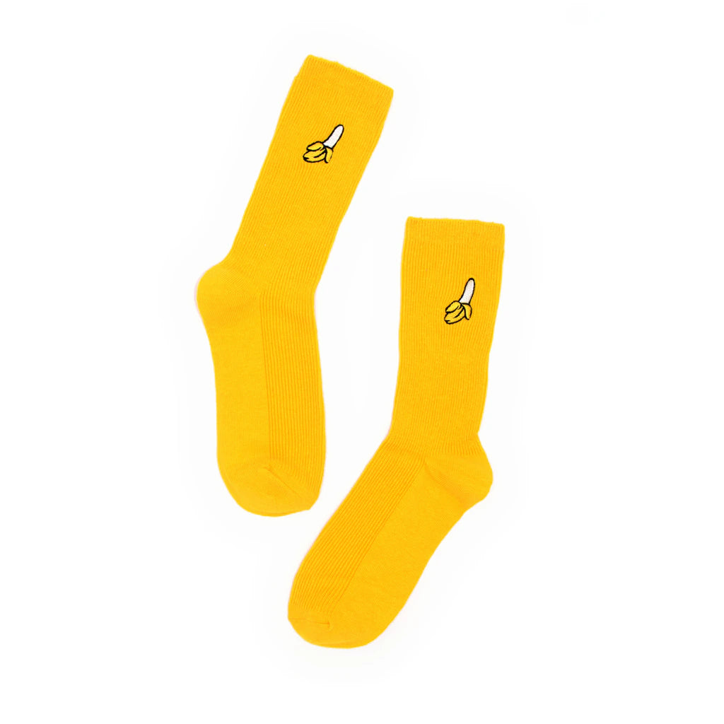 Pair of yellow socks with banana designs on a white background