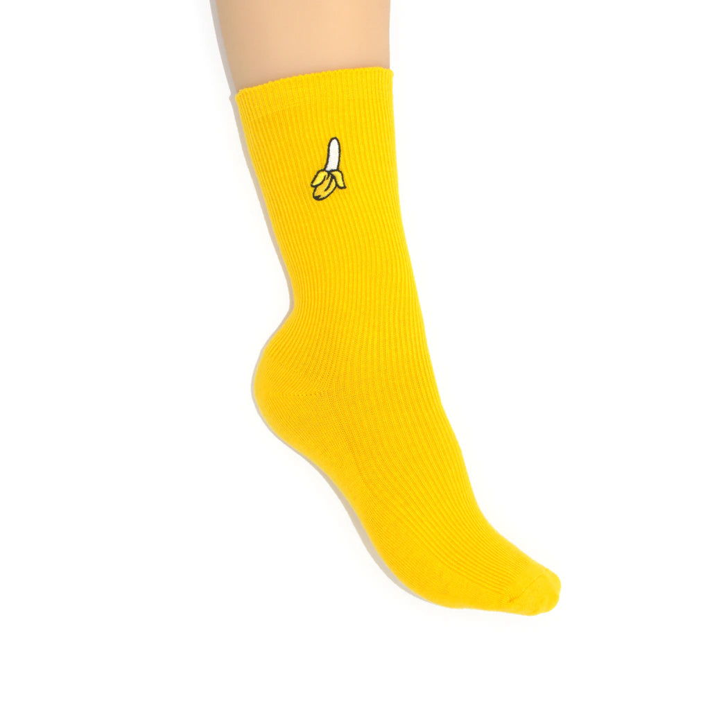Yellow sock with banana design on a white background