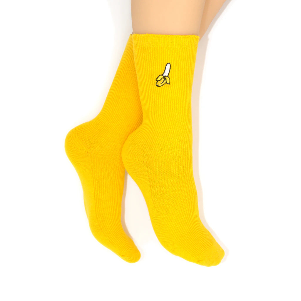 Yellow socks with banana designs on a white background