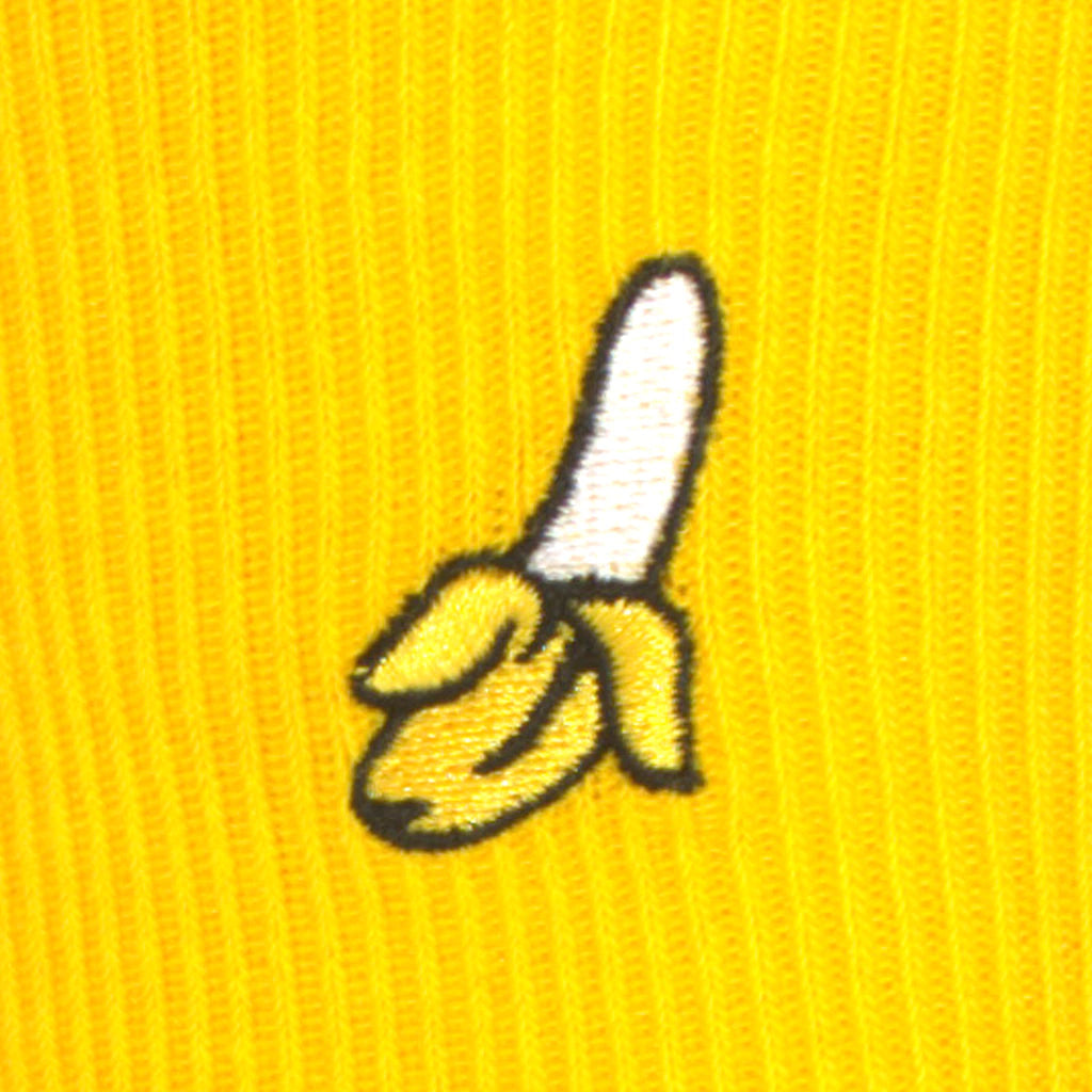 Embroidered banana design on a yellow background