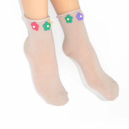 Sheer socks with colorful flower decorations on a white background