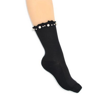 Black sock with pearl embellishments on a white background