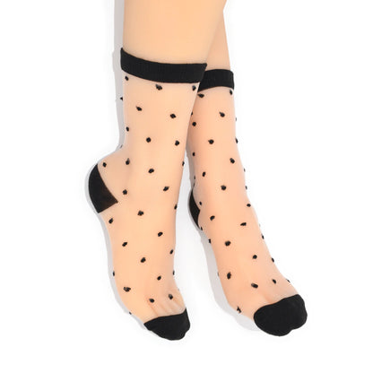 Sheer socks with black polka dots and cuffs on a white background