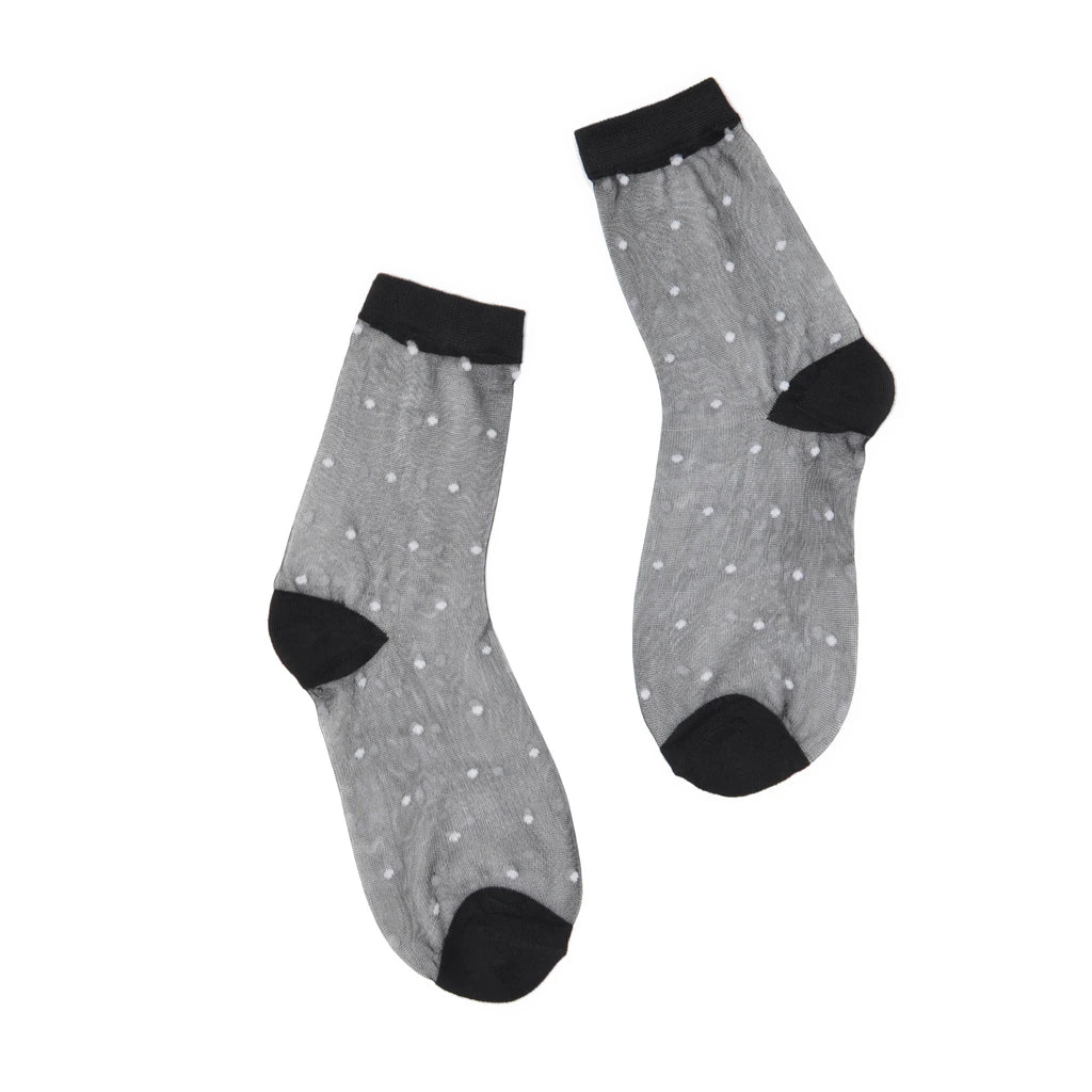 Sheer black socks with white dots, black cuffs and toes on a white background