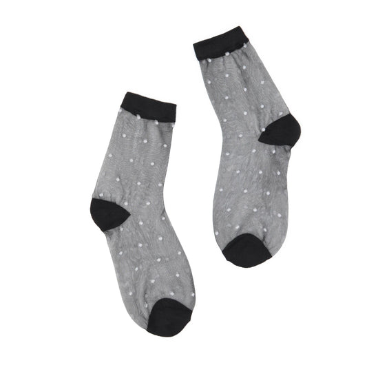 Sheer black socks with white dots, black cuffs and toes on a white background