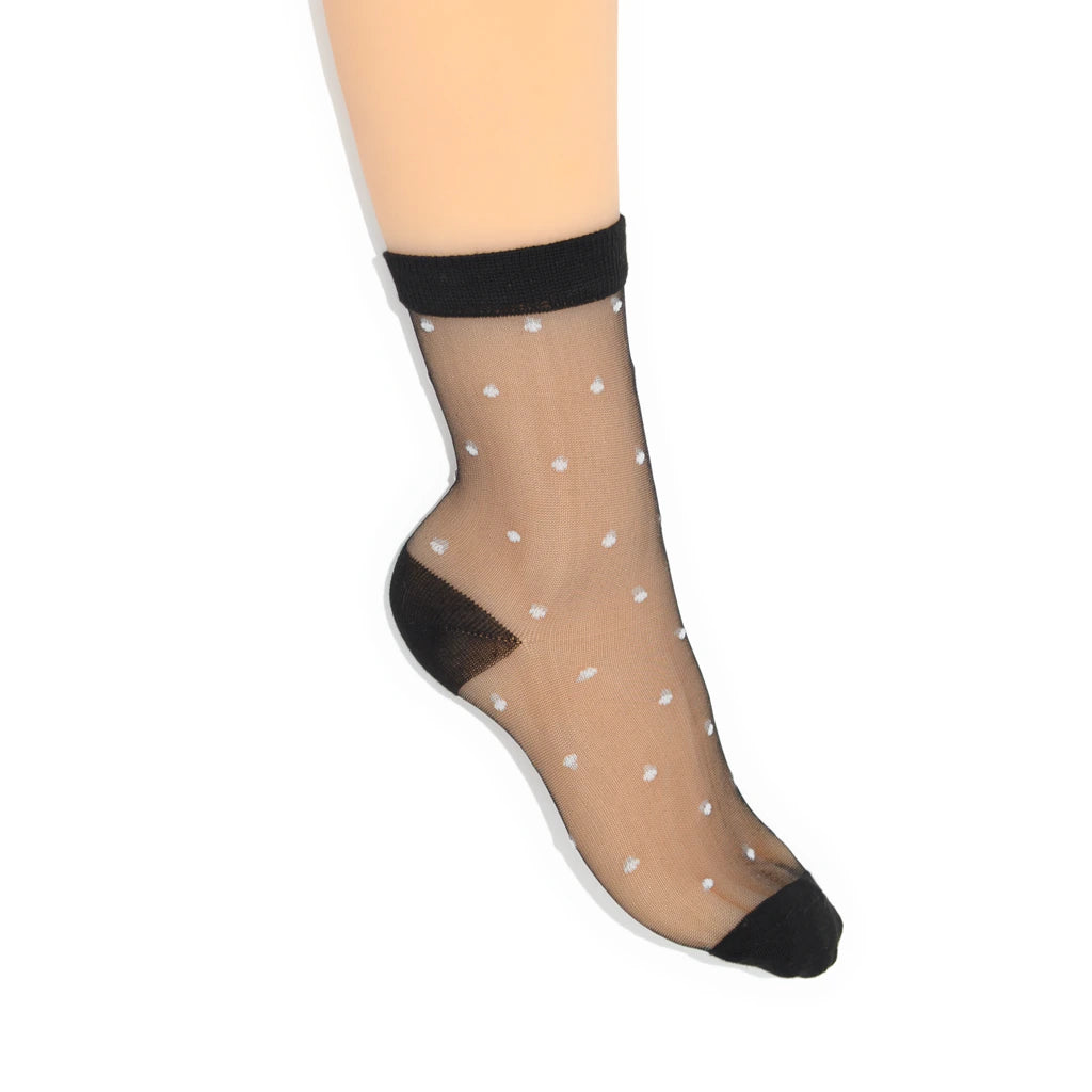 Sheer black ankle sock with white polka dots on a white background