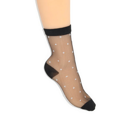 Sheer black ankle sock with white polka dots on a white background
