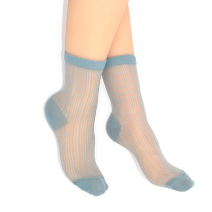 Sheer socks with blue accents worn by a person on a white background