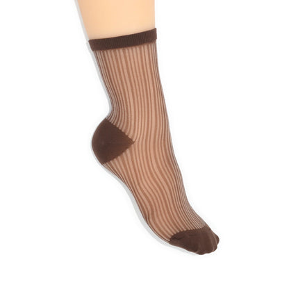 Sheer brown sock with brown top and toe on a foot against a white background