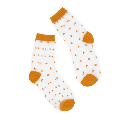 Pair of socks with mustard polka dots and cuffs on a white background