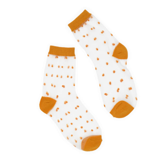 Pair of socks with mustard polka dots and cuffs on a white background