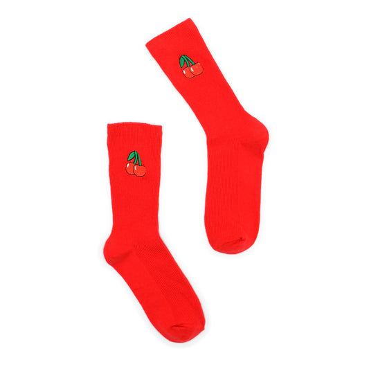 Red socks with cherry design on a white background
