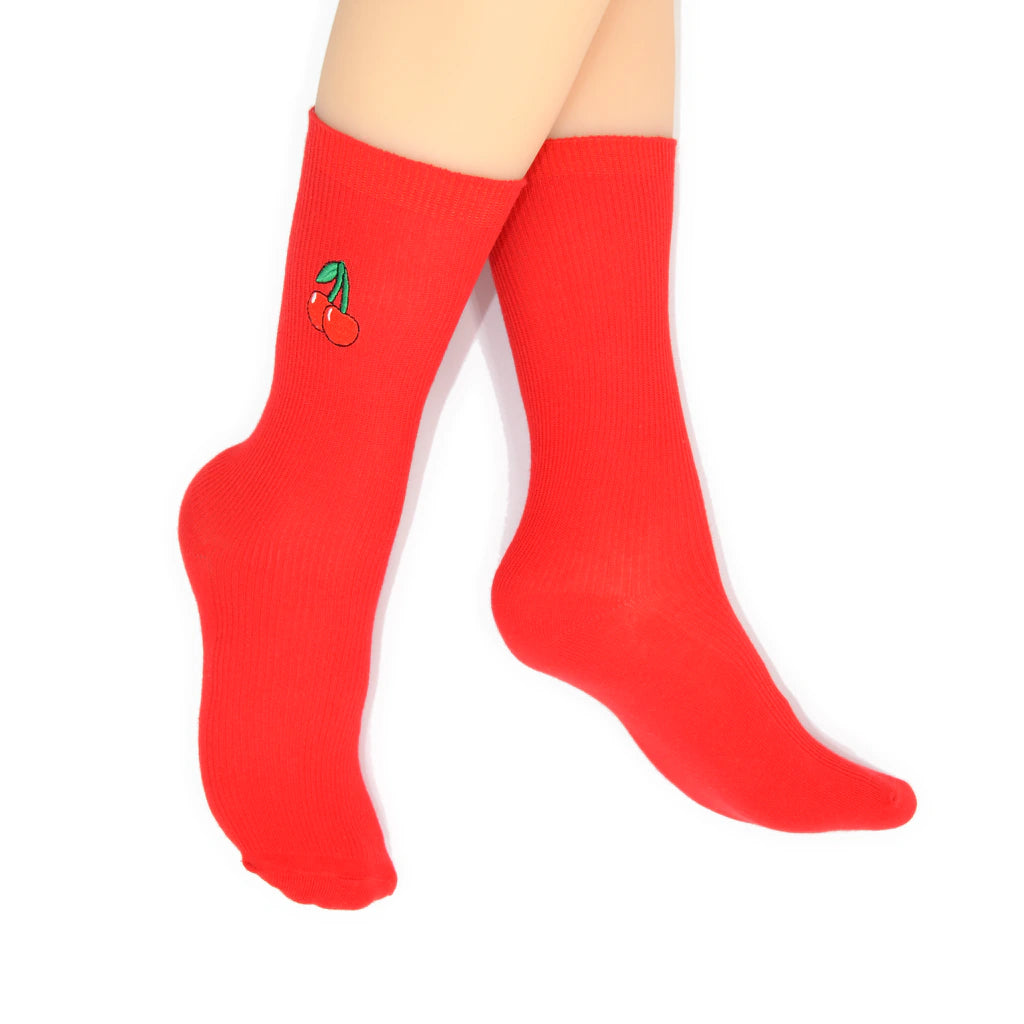 Red socks with a cherry design on a white background