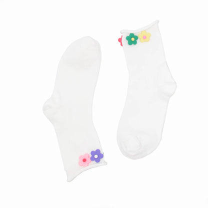White socks with colorful flower designs on a white background