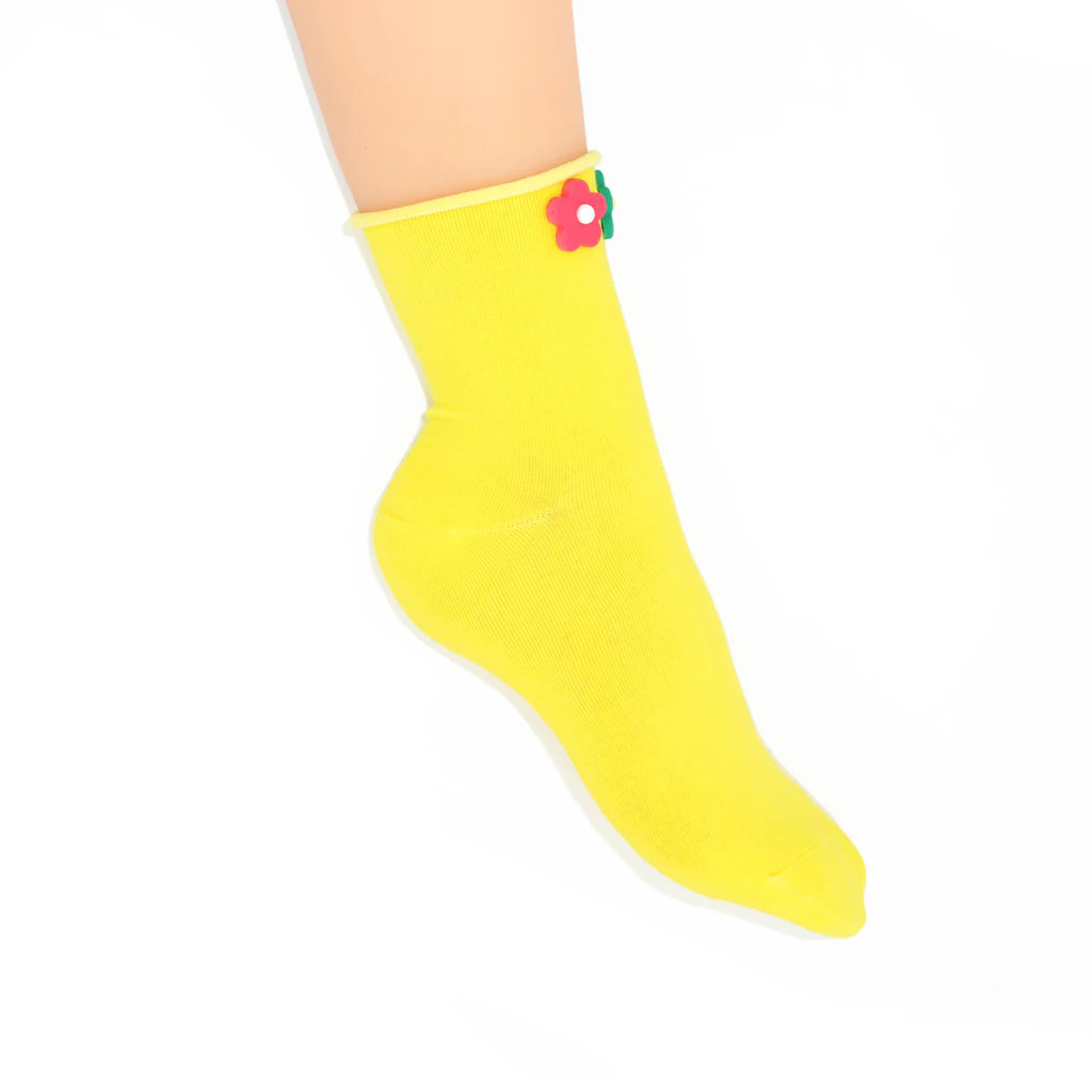 Yellow sock with a flower design on a white background