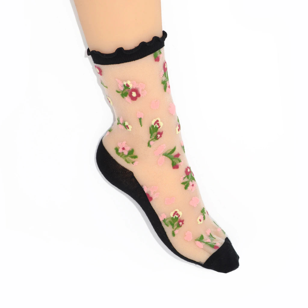 Sheer floral socks with black ruffled top and heel on a white background