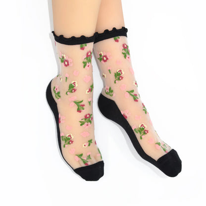 Sheer socks with floral pattern and black toes and cuffs on a white background