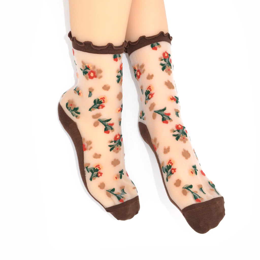 Sheer socks with floral pattern and brown accents on a white background