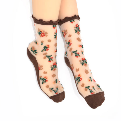 Sheer socks with floral pattern and brown accents on a white background