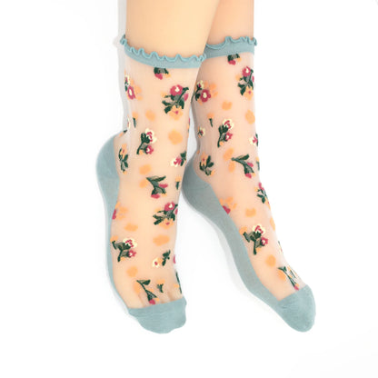Sheer socks with floral pattern and light blue trim on a white background