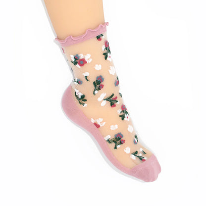 Sheer socks with floral pattern and pink accents on a white background