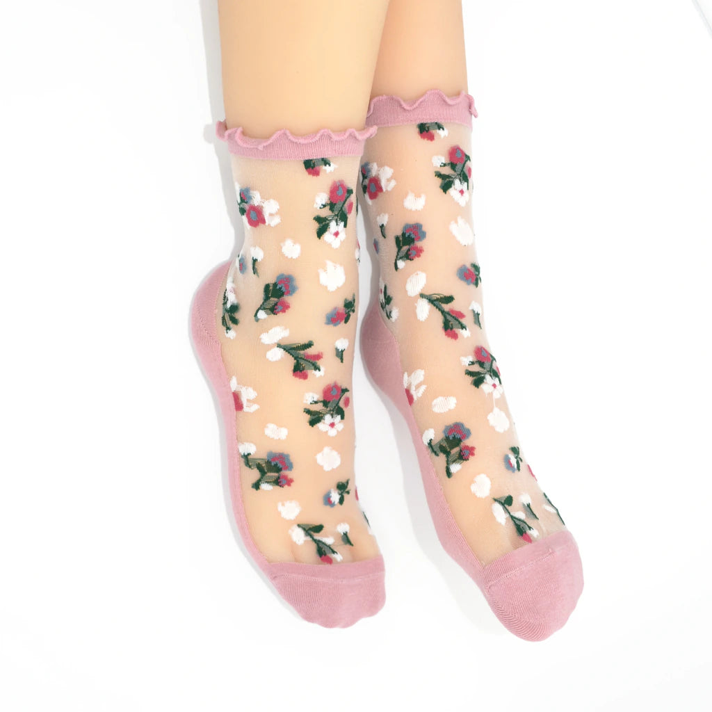 Sheer socks with floral pattern and pink toes and cuffs on a white background
