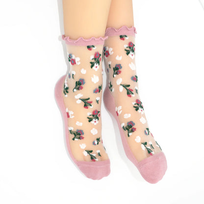 Sheer socks with floral pattern and pink toes and cuffs on a white background