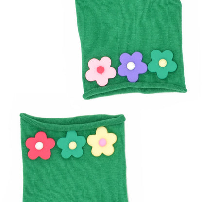 Green socks with colorful flower decorations on a white background