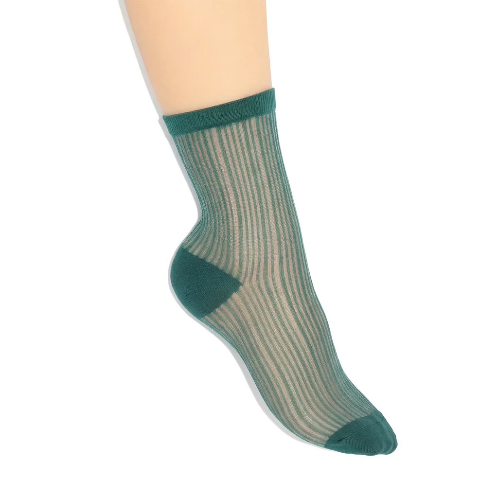 Green  striped sock on a foot against a white background