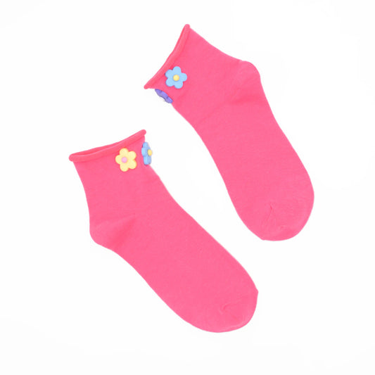 Pair of pink socks with floral designs on a white background
