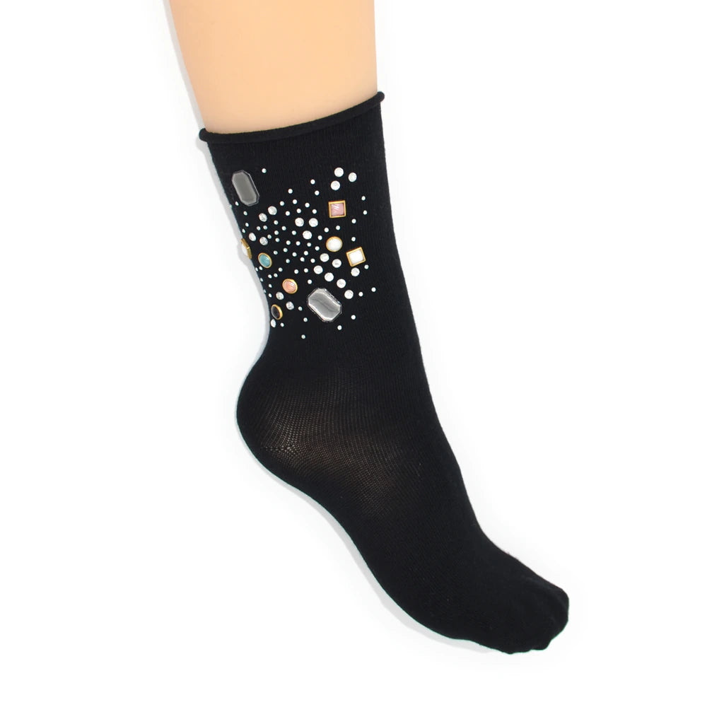 Black sock with decorative stones on a white background