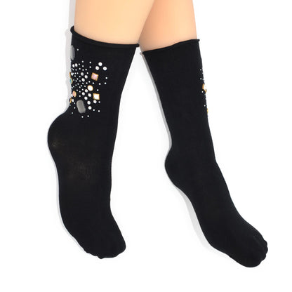 Black socks with decorative elements worn by a person on a white background