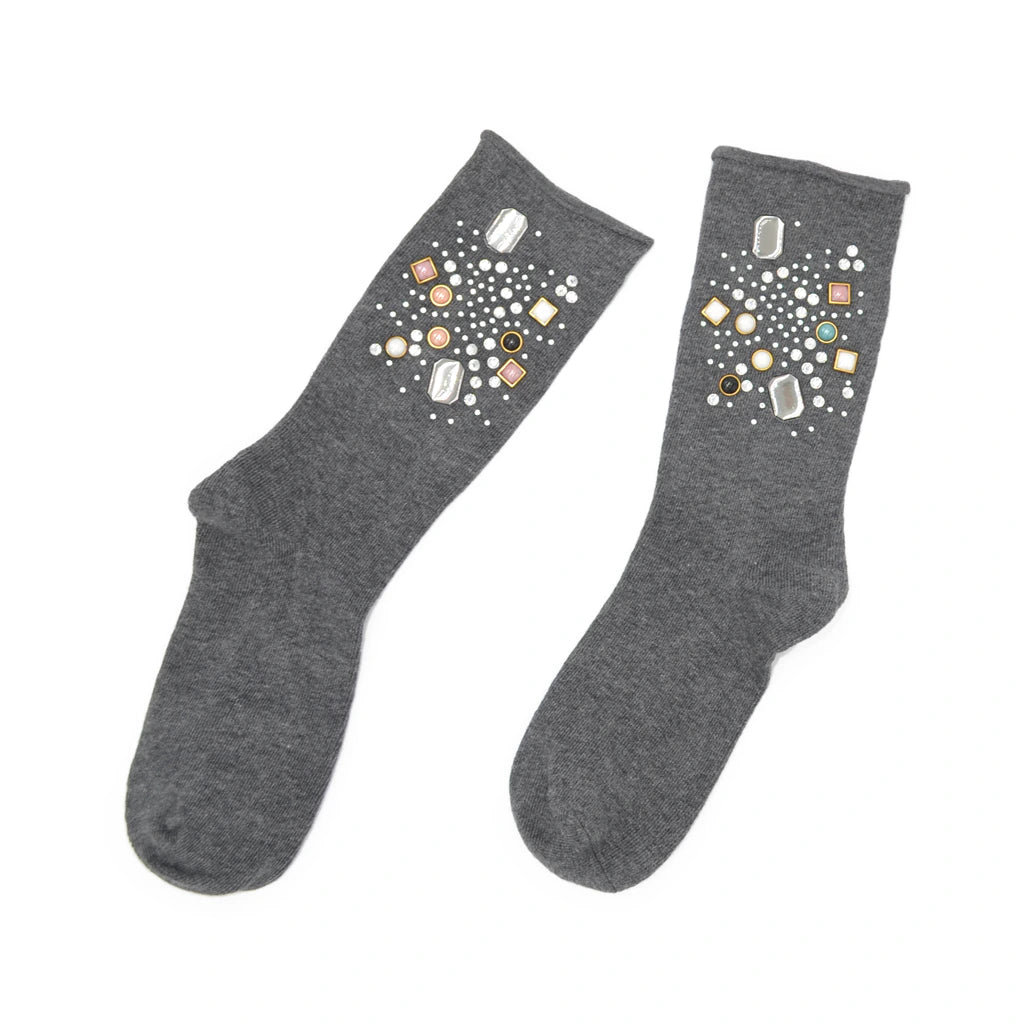 Pair of gray socks with decorative stones on a white background