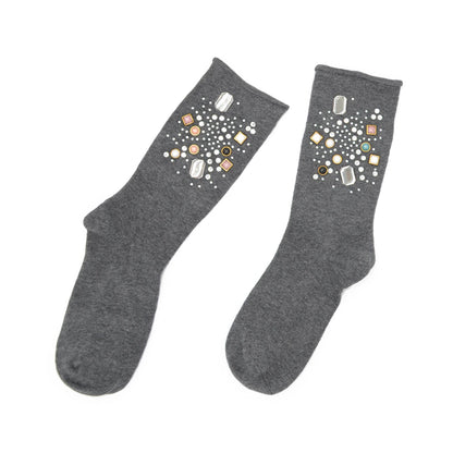 Pair of gray socks with decorative stones on a white background
