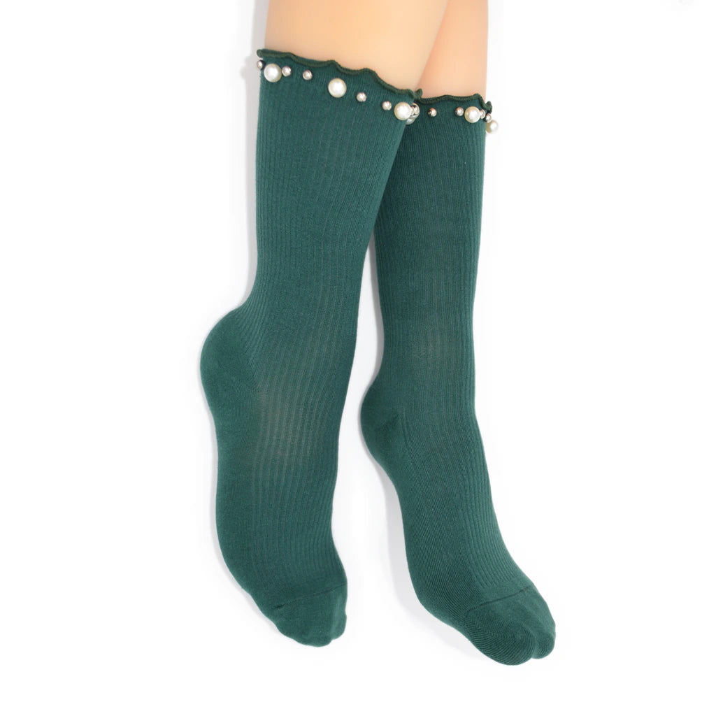 Green socks with pearl embellishments on a white background