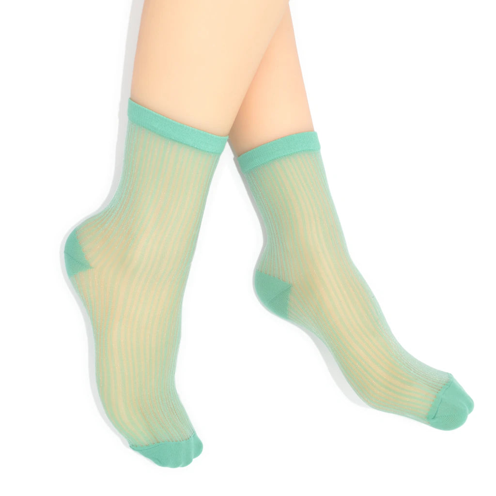 Sheer green socks with solid green tops on a white background