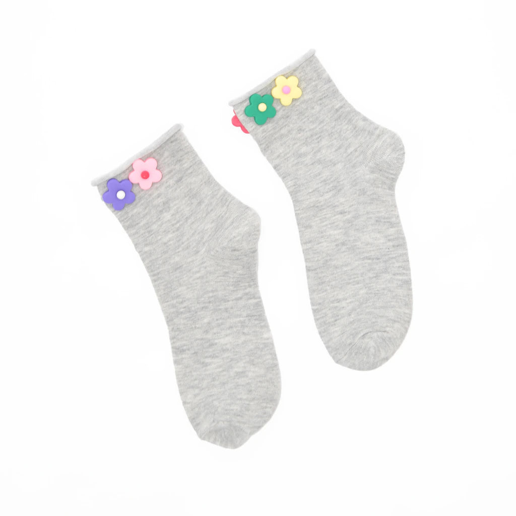 Pair of gray socks with colorful flower decorations on a white background