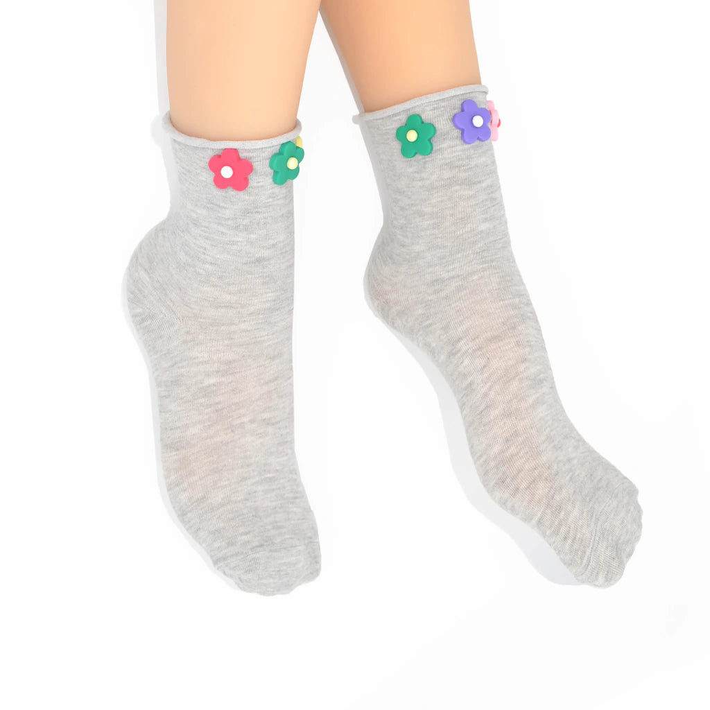 Gray socks with colorful flower decorations on a white background