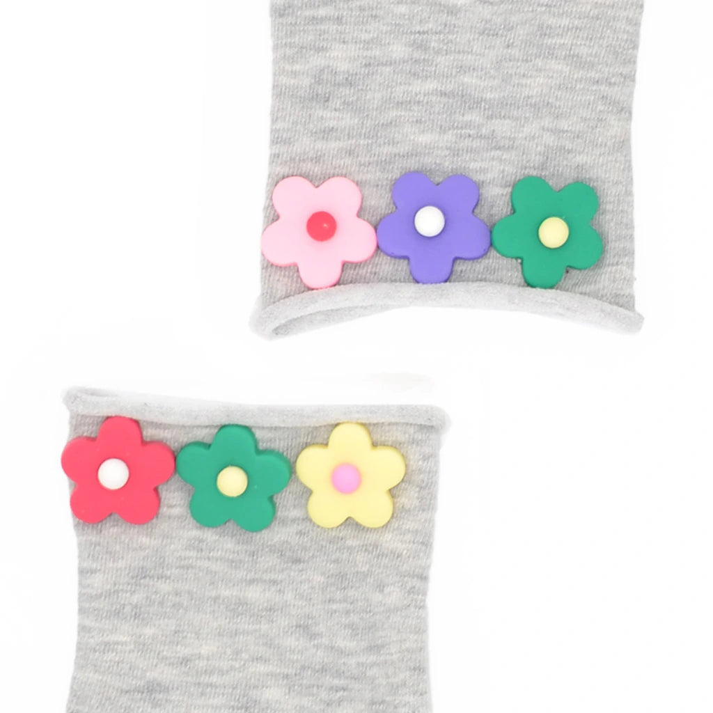 Gray socks with colorful flower decorations on a white background